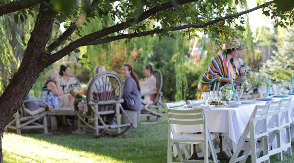 preparing for a group dinner under the apple trees at Casa Gallina in Taos